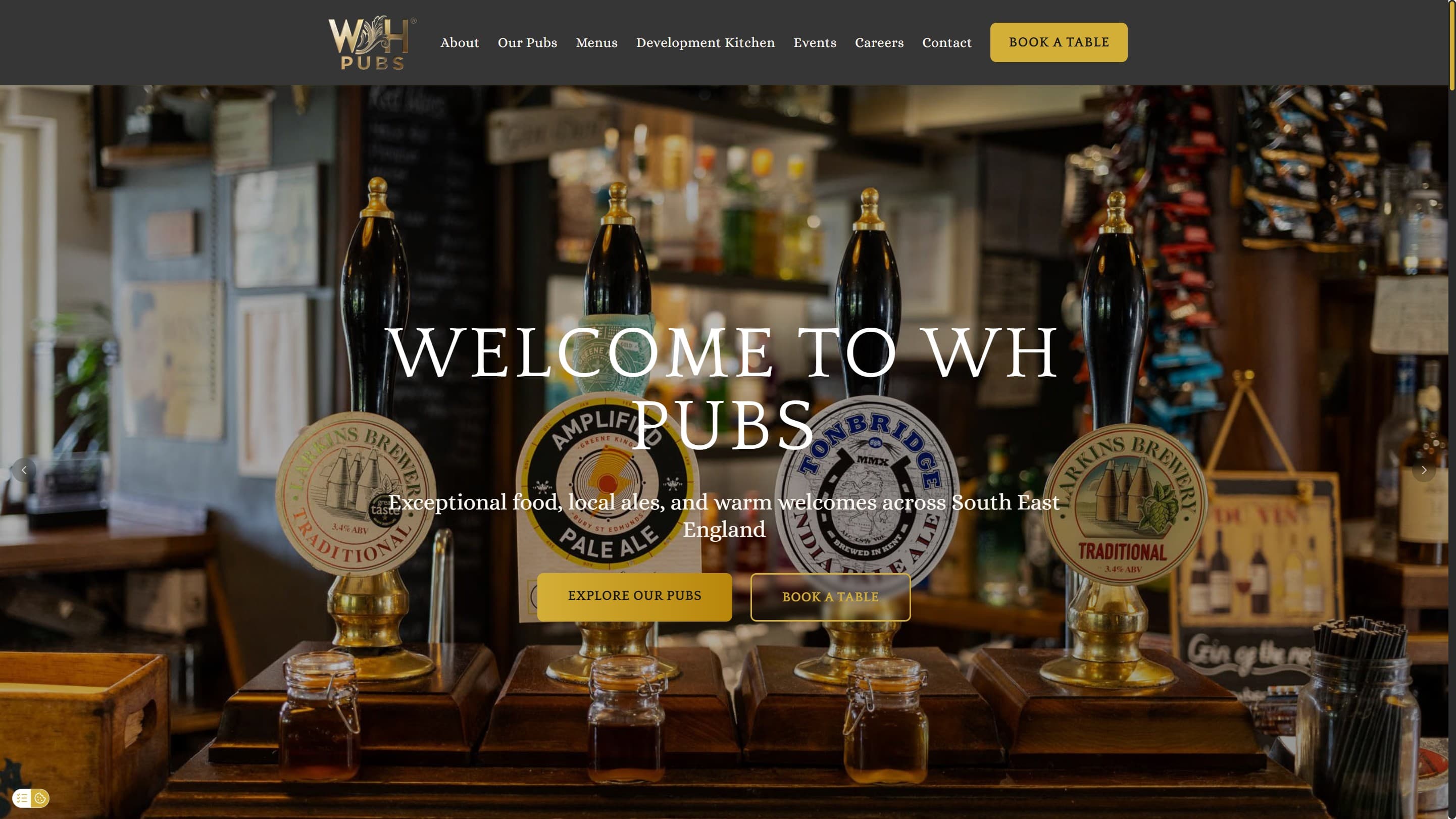The WH Pubs website: a pub bar with hand pulls and a book a table button